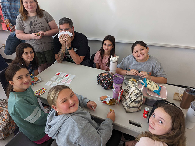 Students sit at a table